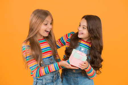 Happy birthday. Small child give present box to birthday girl. Birthday present. Little children...