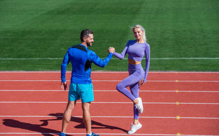 sport people fitness partners celebrate team win with gesture of shake hand after exercising or compete in armwrestling on stadium running track arena outdoor, sport successの写真素材