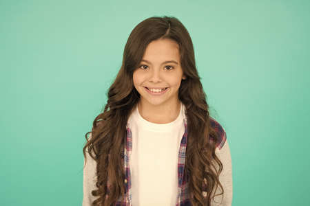 pretty teen girl with long hair, fashion. kid hairdresser concept. Back to school. Studio shot of...