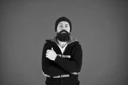 Winter warmness. take care of beard hair in cold weather. autumn and winter collection. brutal hipster in hat. scared bearded man in knitted jacket. you need to dress warmly. male winter fashionの写真素材