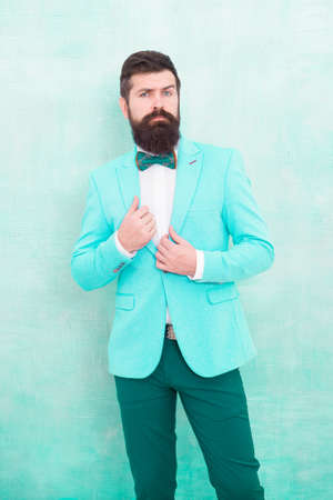 Groom bearded hipster man wear light blue tuxedo and bow tie. Wedding day. Stylish groom. Statement with his stunning crisp suit jacket. Stylist fashion expert. Suit style. Fashion trends for groomの写真素材