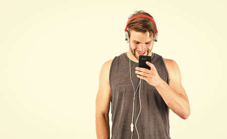 Audio track. Man handsome unshaven hipster listening audio file using headphones gadget.の写真素材