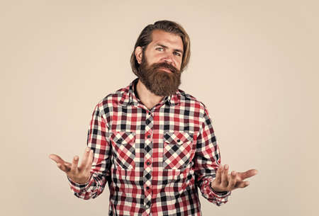 offer to solve the problem. handsome confident man has perfect hairstyle. bearded man in checkered shirt. male beauty. Portrait of bearded hipster. guy with long lush beard and mustache on faceの写真素材