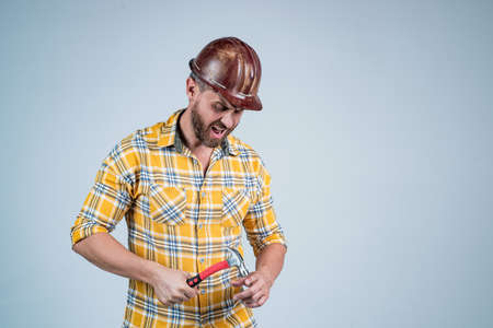 mature builder in shirt. unshaven man on construction site. building worker in hard hat. labor day....