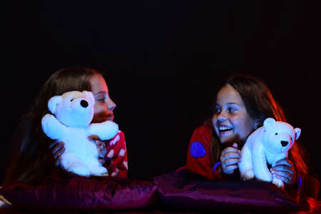 Schoolgirls have pajama party. Girls in pajamas watch play