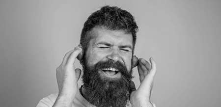 Summer top radio chart. Summer hit concept. Guy enjoy juicy sound summer hit song music. Hipster beard listen music strawberry earphones. Man bearded hipster red ripe strawberry ears as headphonesの写真素材