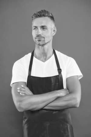 Cafe staff. Barista worker. Man cook wear apron. Mature barista. Restaurant staff. Hipster professional apron uniform. Waiter or bartender. Cafe bar barista job position. Cook good food at homeの写真素材