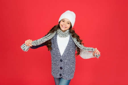 stylish child girl in casual warm apparel with scarf and hat on xmas holidays, carefree childhoodの写真素材