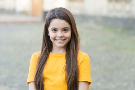 Beauty look of adorable girl child with long hair smile outdoors, beautifulの写真素材