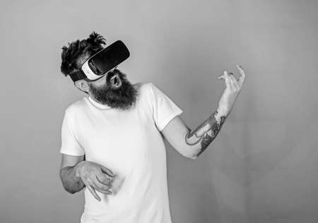Hipster guitarist on enthusiastic face use modern technology for entertainment. Guy with VR glasses...