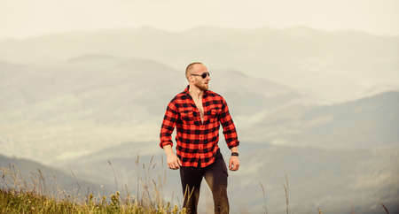 Tourist walking mountain hill. Natural power. Masculine power. Power of nature. Man stand on top of...