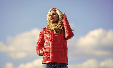 Fashion outfit. Windy day. Matching style and class with luxury and comfort. Girl red jacket cloudy...
