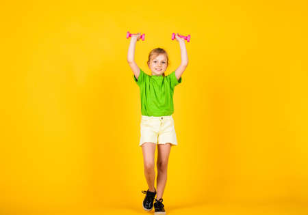 pretty teen girl with barbells tools for training, sport