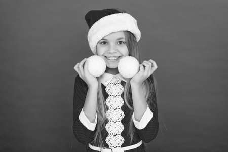 Define the spirit of xmas. Happy child hold xmas tree balls. Little girl decorate Christmas tree. Merry xmas and happy new year. Christmas eve. Christmastime. X-mas. Xmas decorations and ornamentsの写真素材