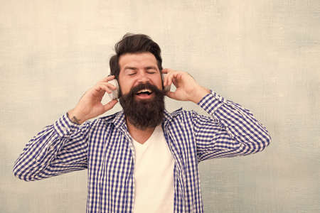 Handsome man in headset listening to music outdoor. Music chose me. Time to relax. full of inspiration. stay creative and stylish. happy male in earphones. summer playlist mood. cool and inspiredの写真素材