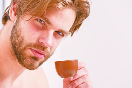 Best time to have your cup of coffee. Guy attractive appearance man enjoy hot fresh brewed coffee close up. First sip. Every morning with his coffee. Man bearded handsome macho hold cup of coffeeの写真素材