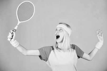 Sport for maintaining health. Woman hold tennis racket in hand. Tennis club concept. Tennis sport and entertainment. Active leisure and hobby. Girl fit slim blonde play tennis. Active lifestyleの写真素材