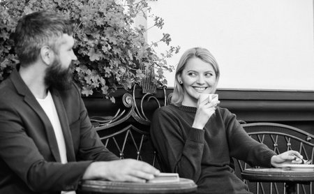 Enjoying beautiful morning. First meet of girl and mature man. woman and man with beard relax in...