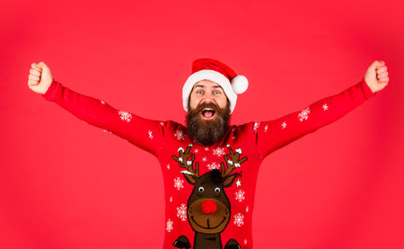 Happy new year. Hipster funny knitted sweater. Celebrating another year with love, happiness and cheer. Cold weather. Bearded man santa hat. Merry christmas. Christmas sale. Christmas celebrationの写真素材