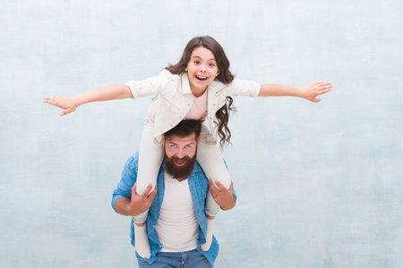 Flight of imagination. Father ride daughter child pretending flying. Happy family have fun together. Playing airplane. Childhood imagination. I believe I can flyの写真素材