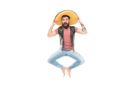 Mexican party concept. Celebrate traditional mexican holiday. Guy happy cheerful face having fun dancing and jumping. Mexican energetic temper. Man bearded cheerful guy wear sombrero mexican hatの写真素材