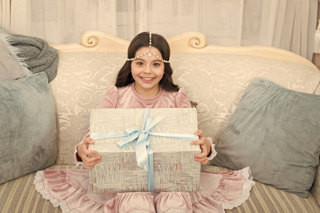 Happy kid opening surprise gift. Delivering happiness. Wait for santa claus. Christmas time. Happy...