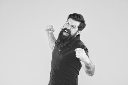 Winner and victory. Joyful guy. Inner energy. Motivated for success. Happy man show success gesture yellow background. Victory and success. Bearded man in casual style celebrating. Happiness and joyの写真素材