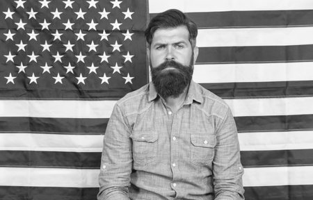serious man at USA national flag. victory and freedom. education and business in america. Students exchange program. American patriotic people. USA Independence Day 4th of Julyの写真素材