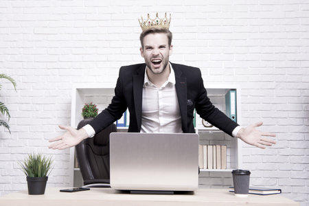 Office king. King of style. Achieving victory and success. Royal and luxury. Glory seeking man. Man representing power and triumph. Business king. Businessman wear crown. Success in businessの写真素材