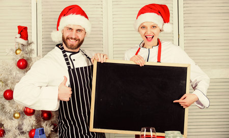 Family traditional menu for christmas dinner. Menu for our family. Man and woman chef santa hat near...