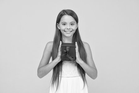 carefree beauty go shopping on cyber monday. smiling kid share present box. little child ready for party celebration. happy childhood. joyful summer holiday. kid with gift boxの写真素材