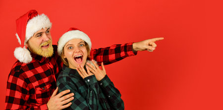 Santa Claus style. Having fun. Christmas time. Man and woman christmas holiday celebration. Family shopping. Christmas party. Couple in love cuddling. Good mood. Couple goals. Winter entertainmentの写真素材