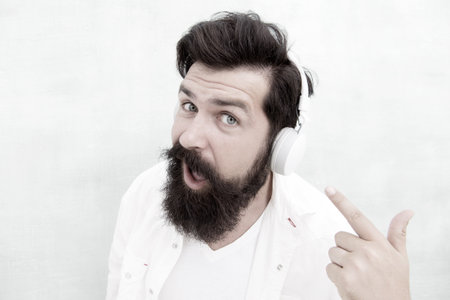 Modern wireless headphones. Electronic dance music tracks. Instrumental music. Bearded man headphones. Enjoy every note. Active Noise Cancellation Technology. Hipster listen music stereo headphonesの写真素材