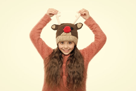 Festive spirit. Cheerful kid. Playful cutie. Why children seems cute. Adorable baby wear cute winter knitted hat. Cute accessories. Girl wear winter theme accessory. Christmas time. Fun and joyの写真素材