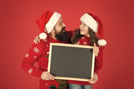 New year and Christmas publicity. Happy family hold blank publicity board. New year and xmas...