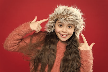 Wardrobe and boutique. small child ready for winter. happy little girl in earflap hat. seasonal health care. warm kid fashion. holiday activity outdoor. Keeping style and giving warmthの写真素材