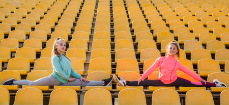 girls kids training sport outside on stadium tribune sit in split, sportの写真素材