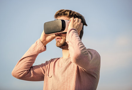 New innovations. man wear wireless VR glasses.. sexy man sky background vr glasses. create own business. Digital future and innovation. male reality. Future technology. guy virtual reality gogglesの写真素材