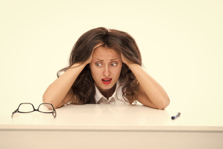 Shocked business woman. full of work. oh my god. stressed with hand on head. shocked with shame and surprise face. angry and frustrated lady. feeling fear and upset for mistake. back to schoolの写真素材