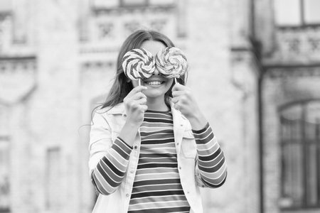 Little girl enjoy summer vacation eat sweets, look at me conceptの写真素材