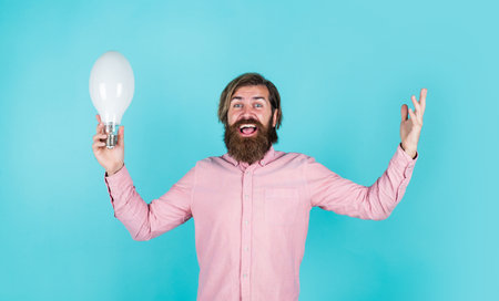 brutal bearded male man hold lamp bulb, energyの写真素材