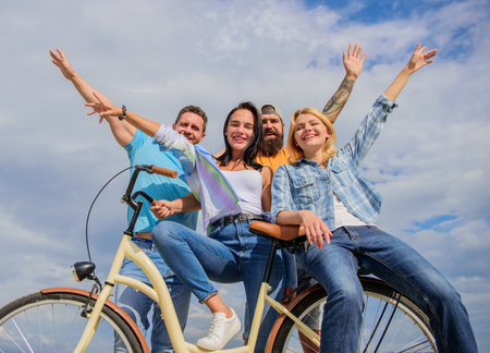 Company stylish young people spend leisure outdoors sky background. Bicycle as part of life. Cycling...