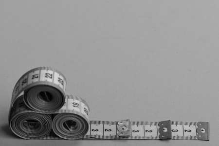 Creative measurements idea. Tape measures of cyan, blue, yellow colors placed in pyramid