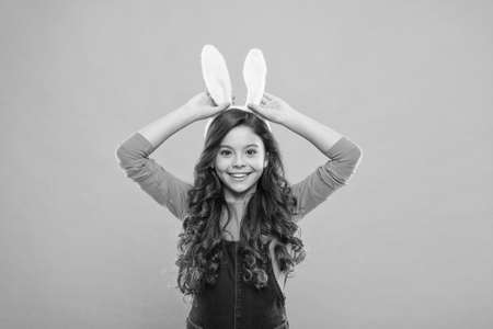 Happy bunny rabbit. Little girl wear rabbit ears. Beauty look of baby rabbit. Small child celebrate Easter. Fashion and style. Holiday celebration. Spring seasonの写真素材