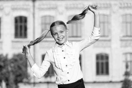 Little girl play with long healthy shiny hairstyle, cute hairdo conceptの写真素材