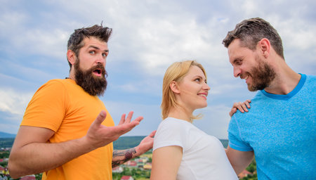 Girl stand between two men. Couple and rejected partner. Woman picked boyfriend. Love as competition concept. She made her choice. Start romantic relationships. Ways to be man for your girlfriendの写真素材