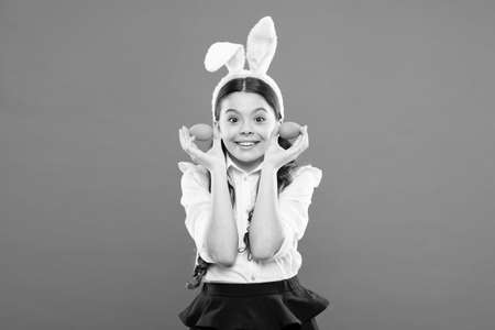 Only fun on my mind. Indoor and outdoor holiday activities. Fun and educational Easter activity for kids. Little girl easter eggs. Cute bunny schoolgirl celebrate Easter day. Preparing decorationsの写真素材