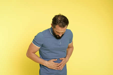 Sore stomach is killing me. Sick man suffer from stomach ache. Constipation and indigestion. Stomach...