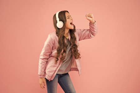 Imagine she is a star. Karaoke party fun. Fun and entertainment. Joining in a song. Small girl with...