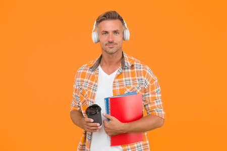 Never too late to study. Educational technology. Study again. Audio book concept. Worldwide knowledge access. Audio library. Another way of study. Man handsome college student headphones booksの写真素材